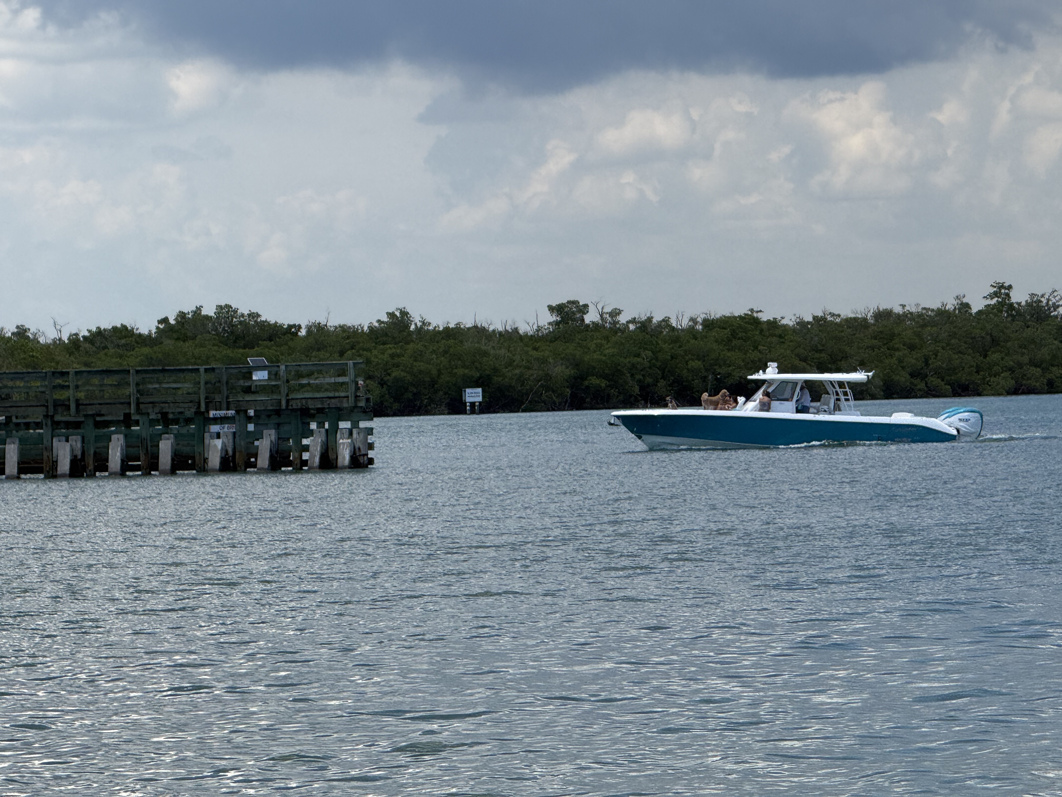 Boat passing under Marco Island bridge